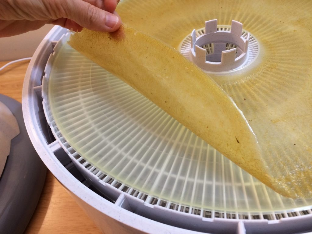 Removing dried applesauce from dehydrator tray